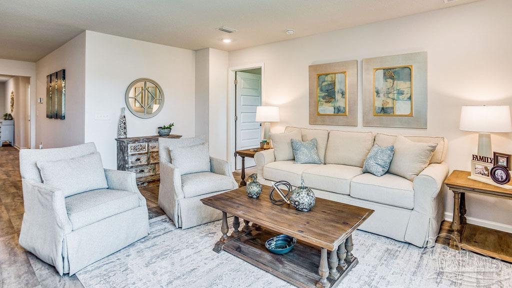 5078 Rainwater Road Milton, FL 32583 - Photo 10 of 26 a living room with furniture a rug and a window