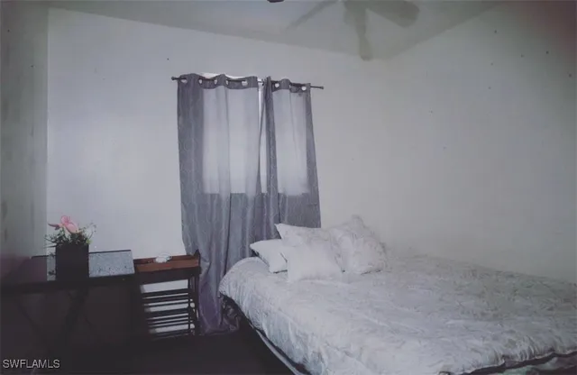 a bedroom with a bed and a table