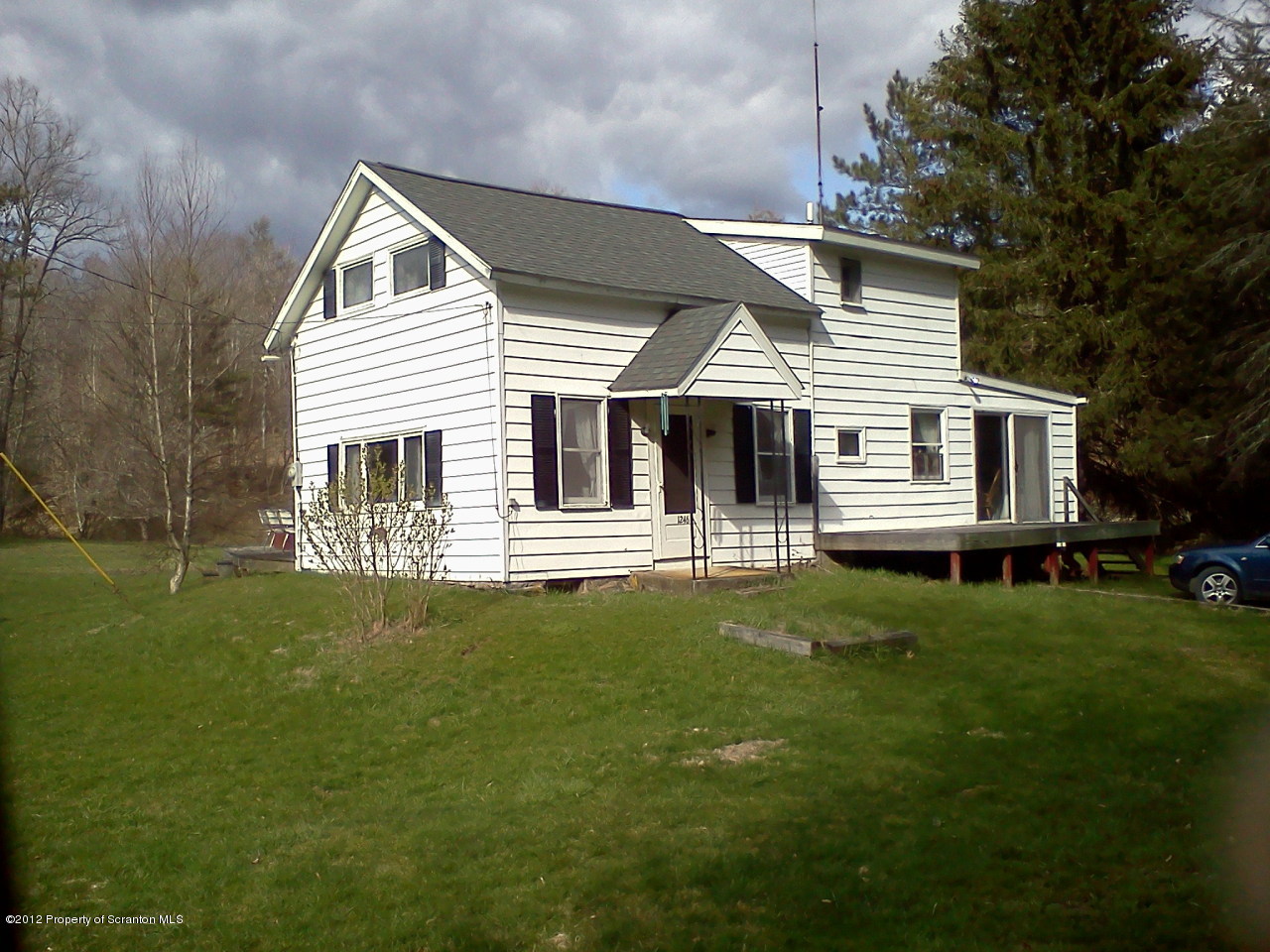 1246 Franklin Road Kingsley, PA 18826 - Photo 1 of 14 a front view of a house with a garden