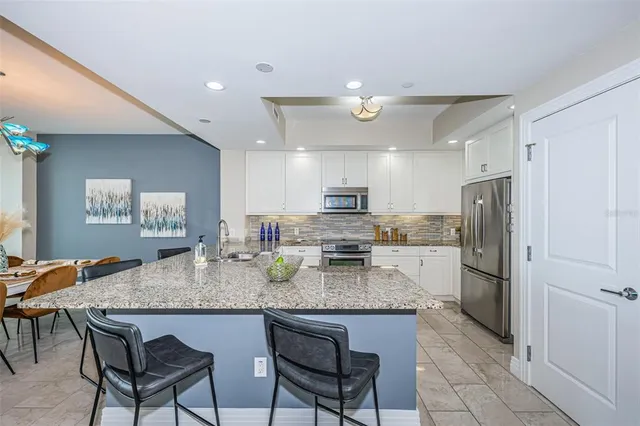 a kitchen with refrigerator cabinets dining table and chairs