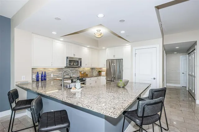 a kitchen with center island and stainless steel appliances