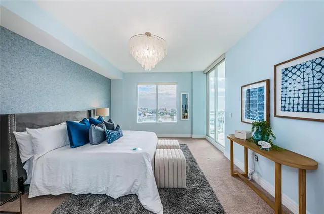 a bedroom with bed and wooden floor