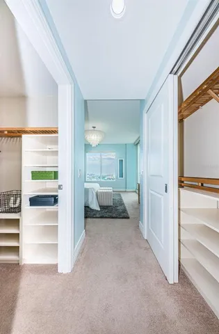 a view of a hallway with a livingroom and a couch
