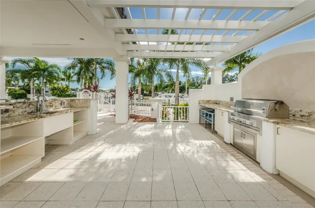 a kitchen with stainless steel appliances a stove a sink and white cabinets