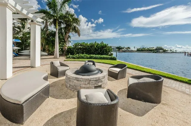 a view of swimming pool with outdoor seating and plants
