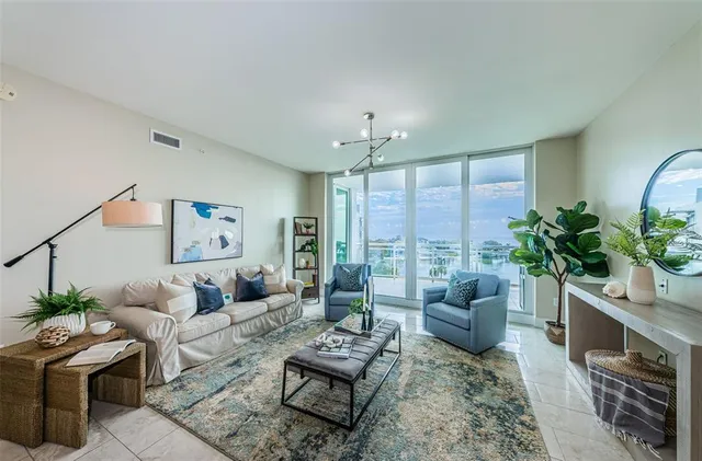a living room with furniture potted plant and a window