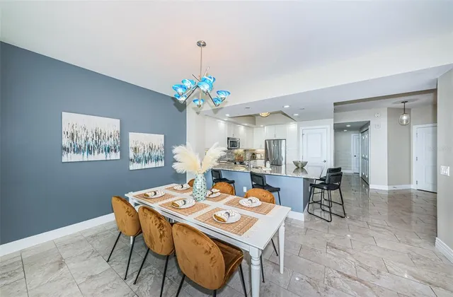 a view of a dining room with furniture and chandelier
