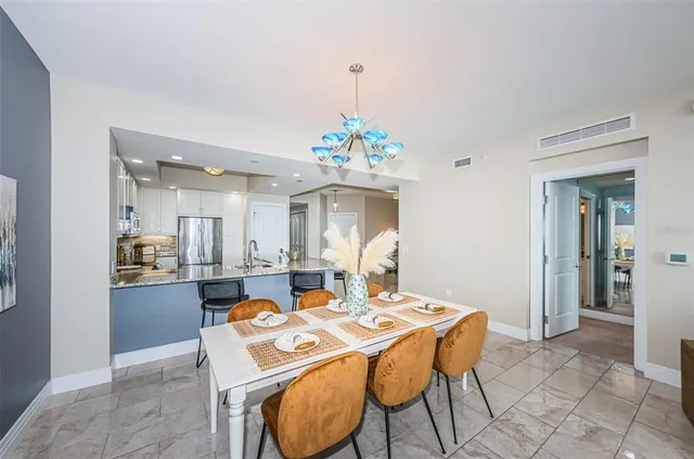 a dining room with a table and chairs