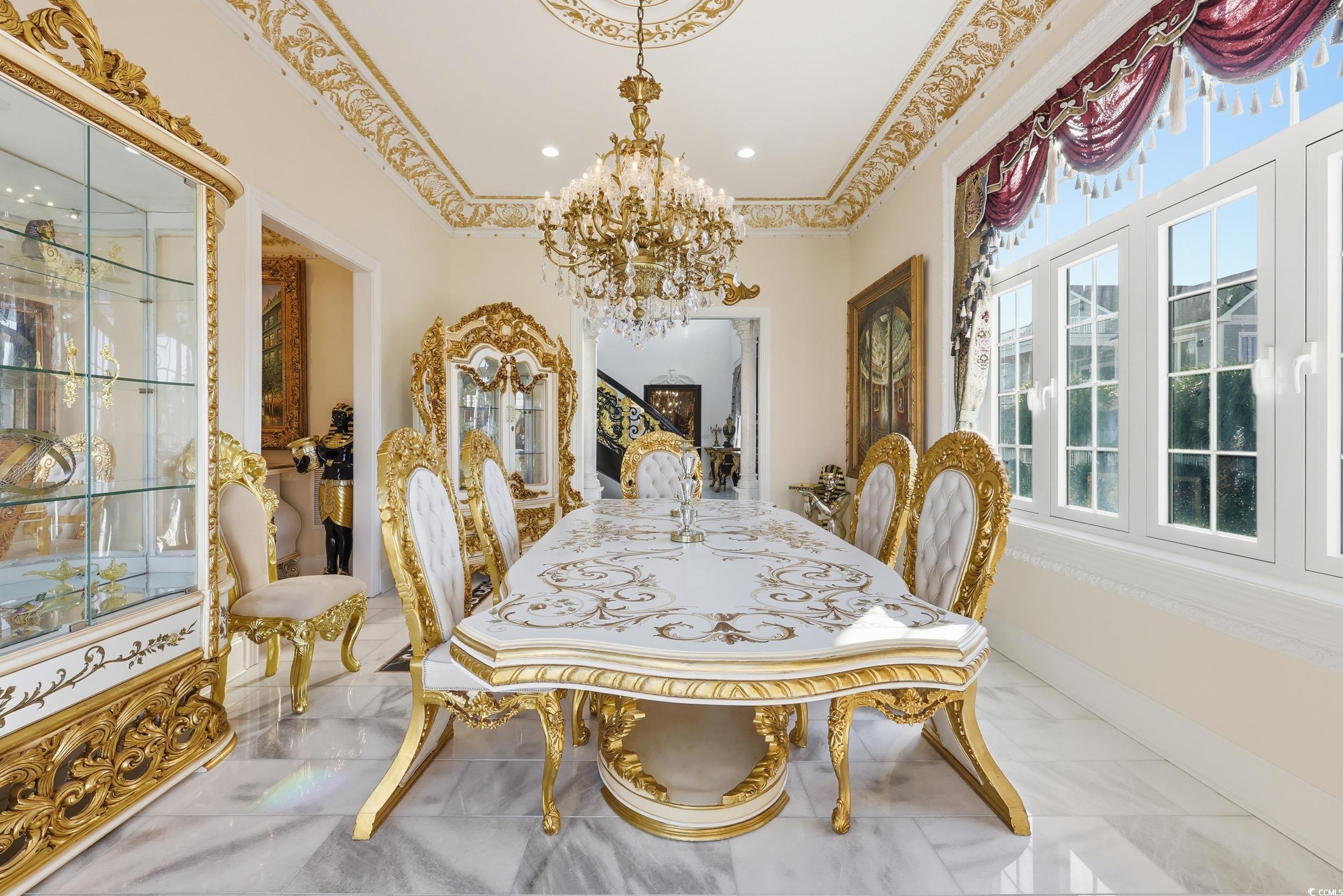 123 Pioneer Loop Georgetown, SC 29440 - Photo 11 of 40 Dining area with a chandelier, marble finish flooring, and crown molding