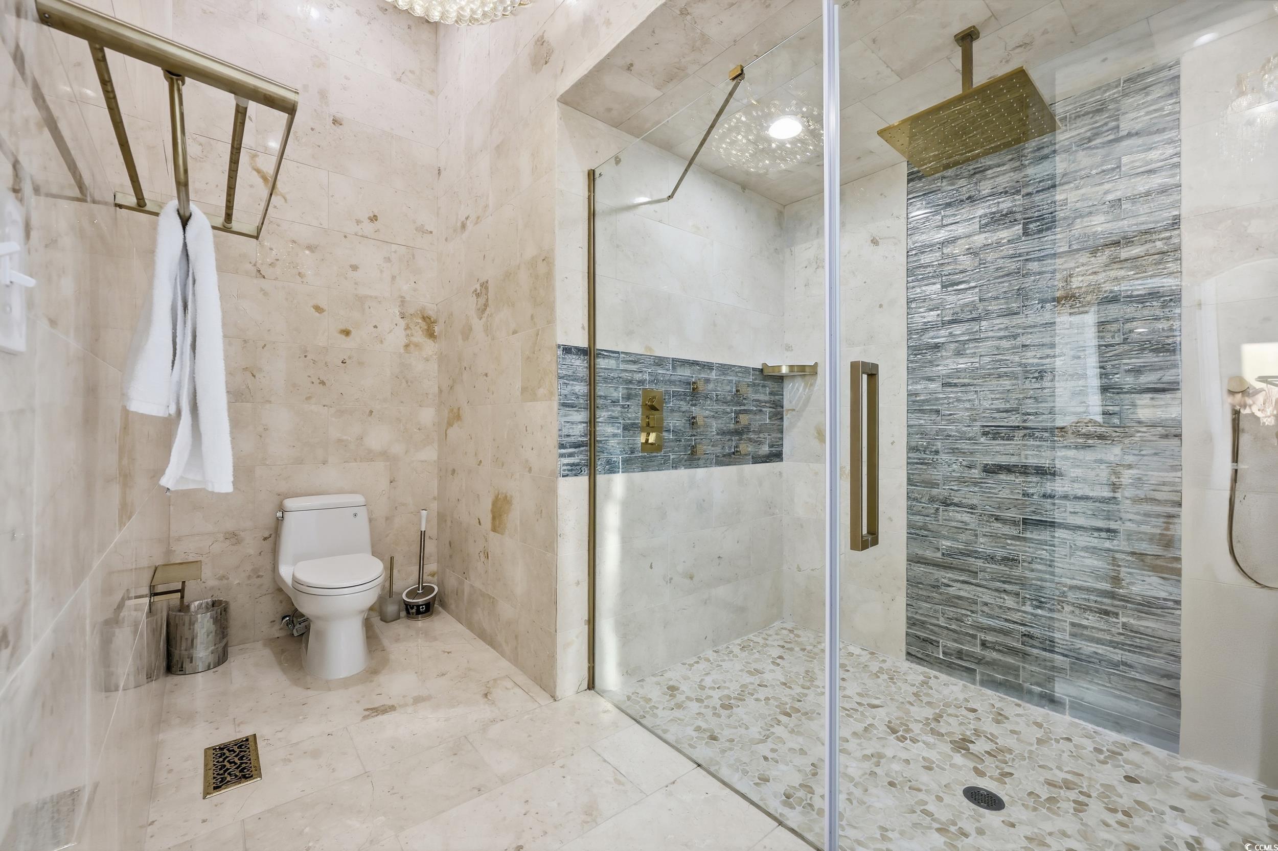 123 Pioneer Loop Georgetown, SC 29440 - Photo 18 of 40 Full bathroom featuring tile walls, a shower stall, and tile patterned floors