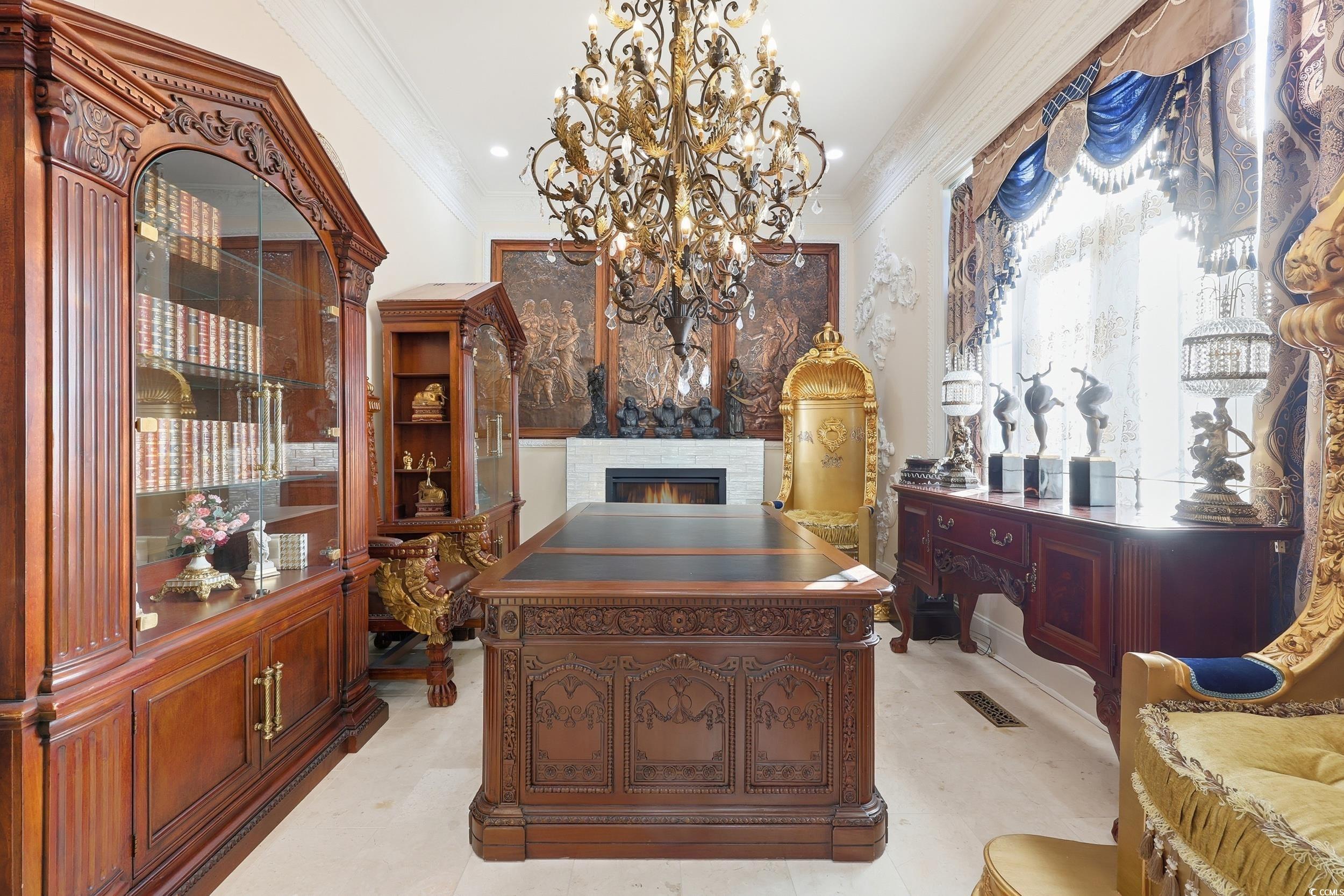 123 Pioneer Loop Georgetown, SC 29440 - Photo 19 of 40 Office area featuring ornamental molding, a chandelier, and a lit fireplace