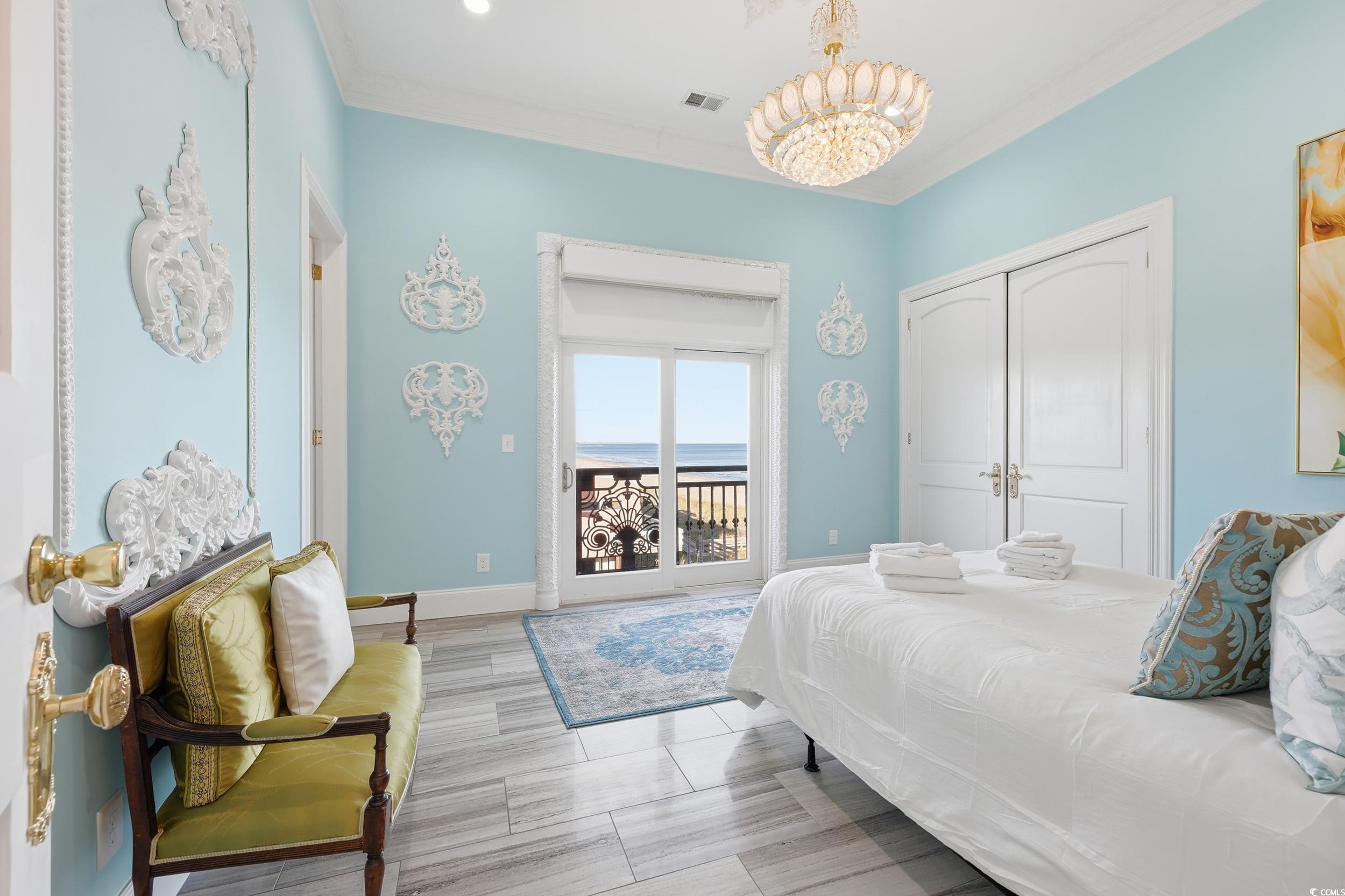 123 Pioneer Loop Georgetown, SC 29440 - Photo 22 of 40 Bedroom featuring access to outside, crown molding, a chandelier, and a closet