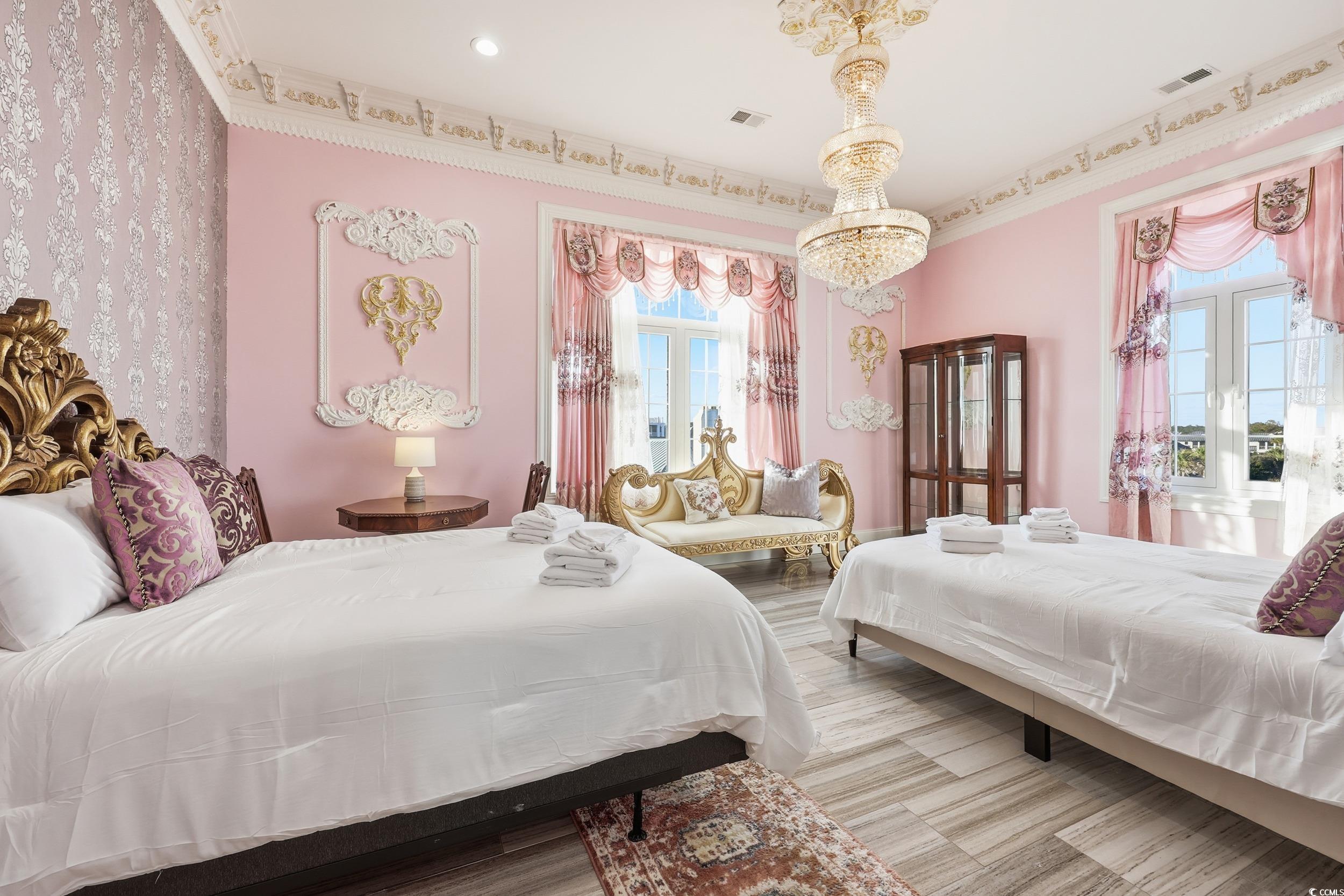 123 Pioneer Loop Georgetown, SC 29440 - Photo 24 of 40 Bedroom featuring crown molding, a chandelier, and wood finished floors