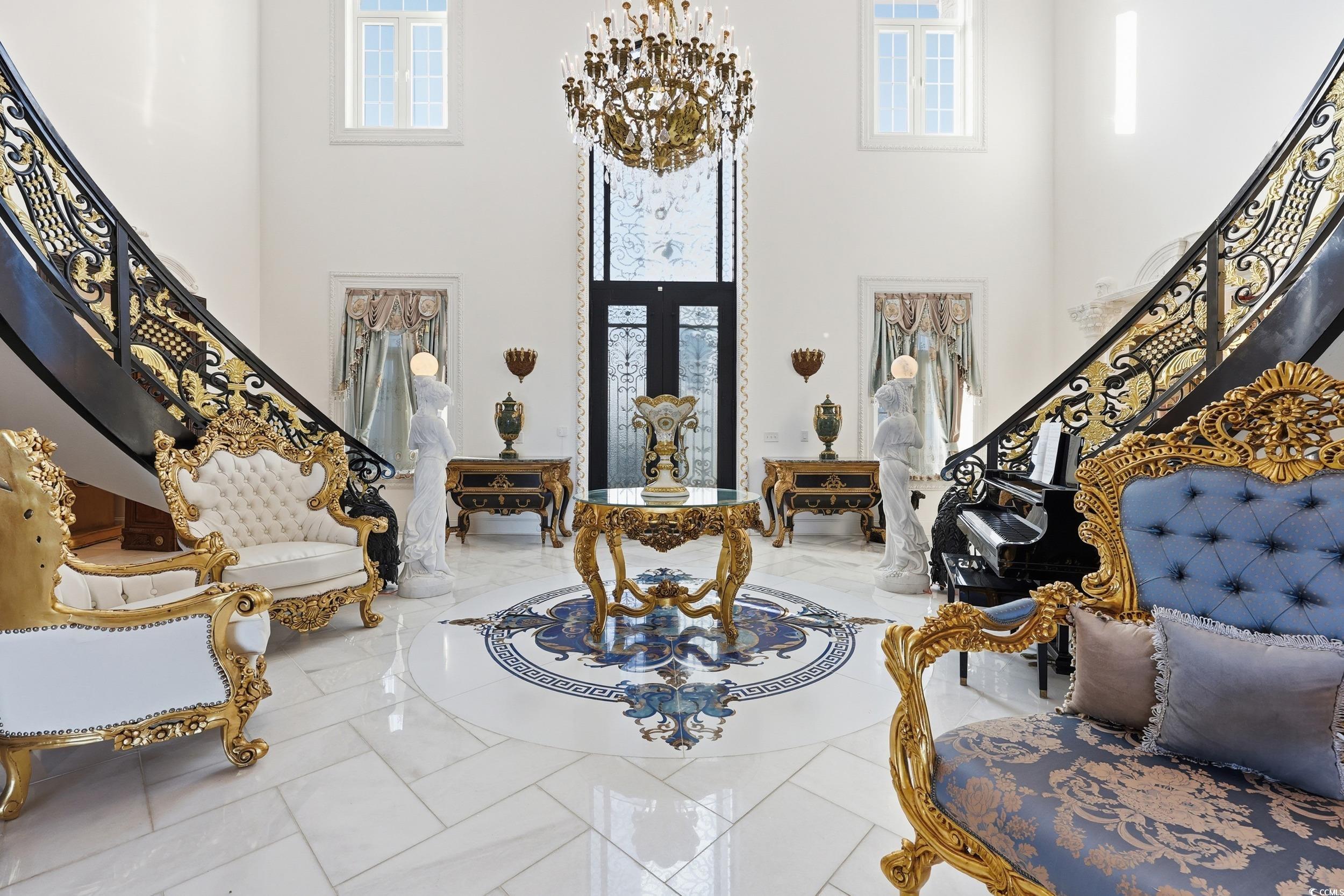 123 Pioneer Loop Georgetown, SC 29440 - Photo 7 of 40 Foyer featuring stairway, a chandelier, and a towering ceiling