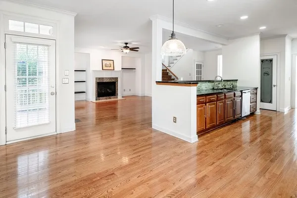 a kitchen with stainless steel appliances granite countertop a stove a sink and a wooden floors