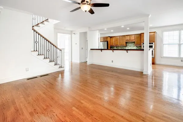 a view of a kitchen with a sink and wooden floor