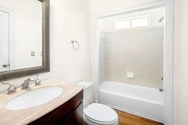a bathroom with a granite countertop sink toilet and shower