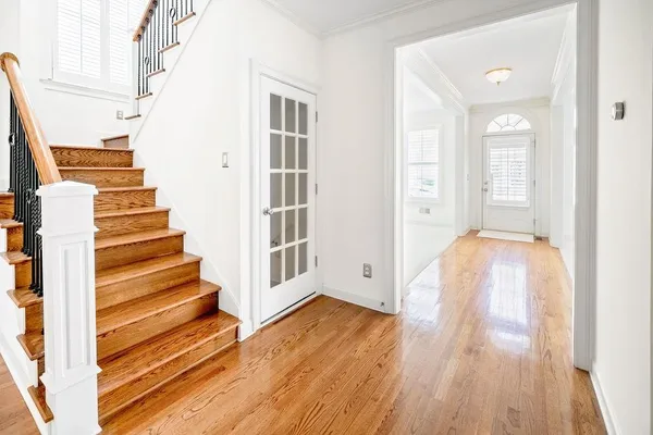 a view of a room with wooden floor and stairs