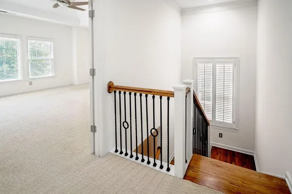 an entryway with wooden floor and windows
