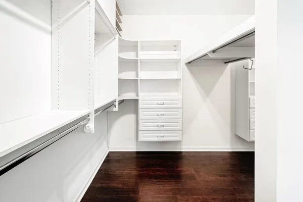 a view of walk in closet with empty racks