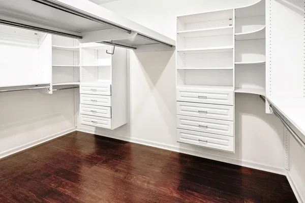 a view of walk in closet with empty racks