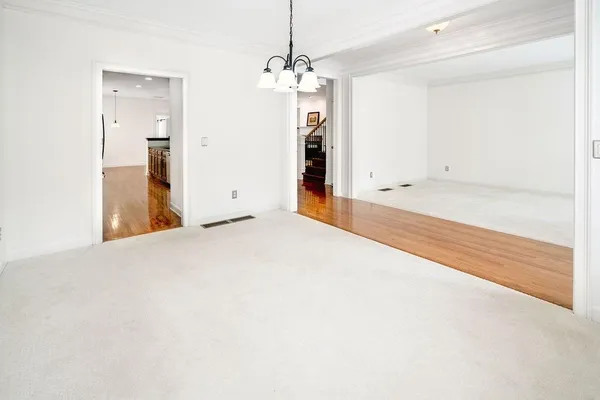a view of a room with wooden floor