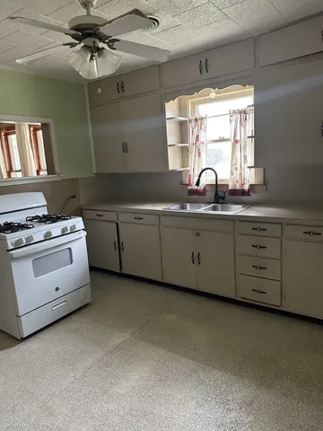 a kitchen with cabinets a sink and appliances