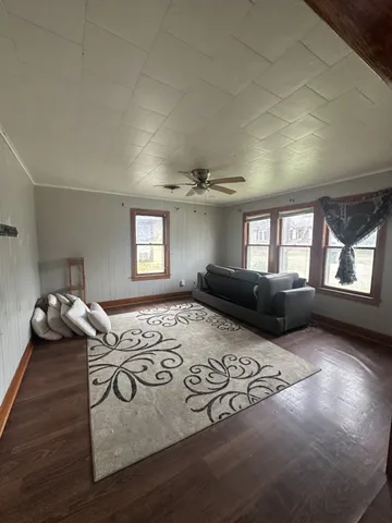 a living room with furniture window and dresser