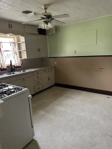 a kitchen with a refrigerator and a stove