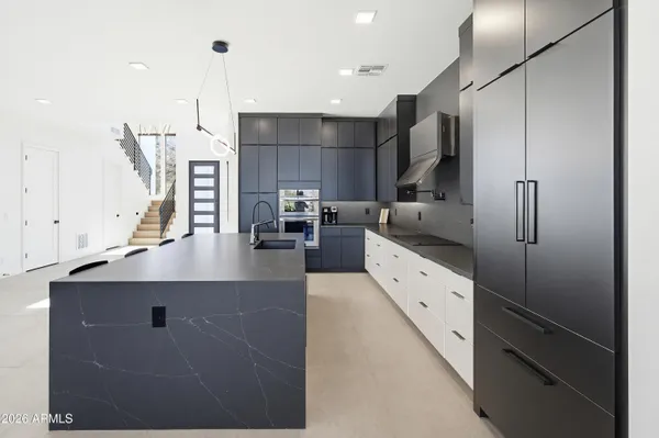 a kitchen with stainless steel appliances kitchen island granite countertop a sink and cabinets