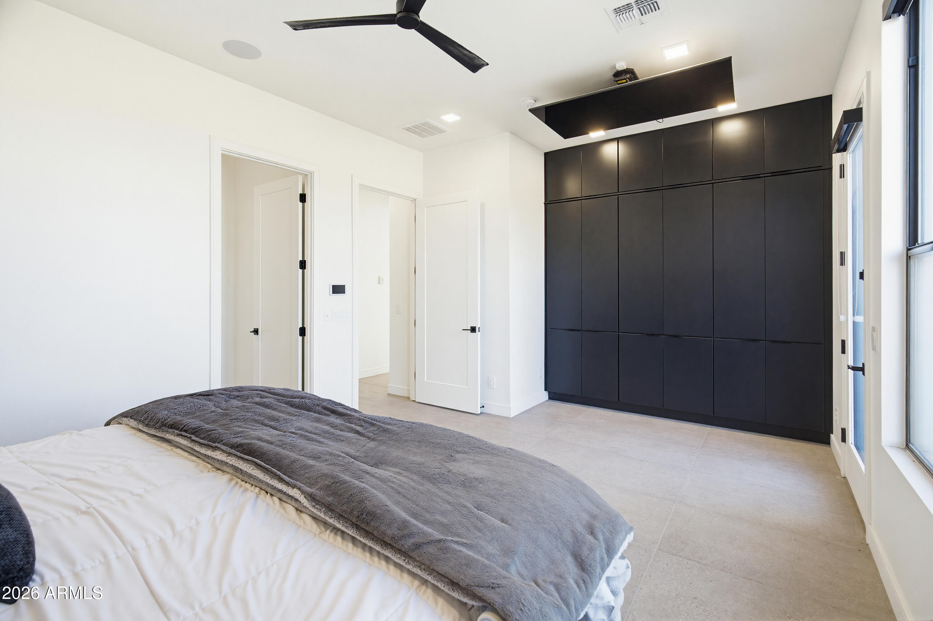 3350 East Highline Canal Road Phoenix, AZ 85042 - Photo 30 of 105 a bedroom with a large bed and a chandelier fan