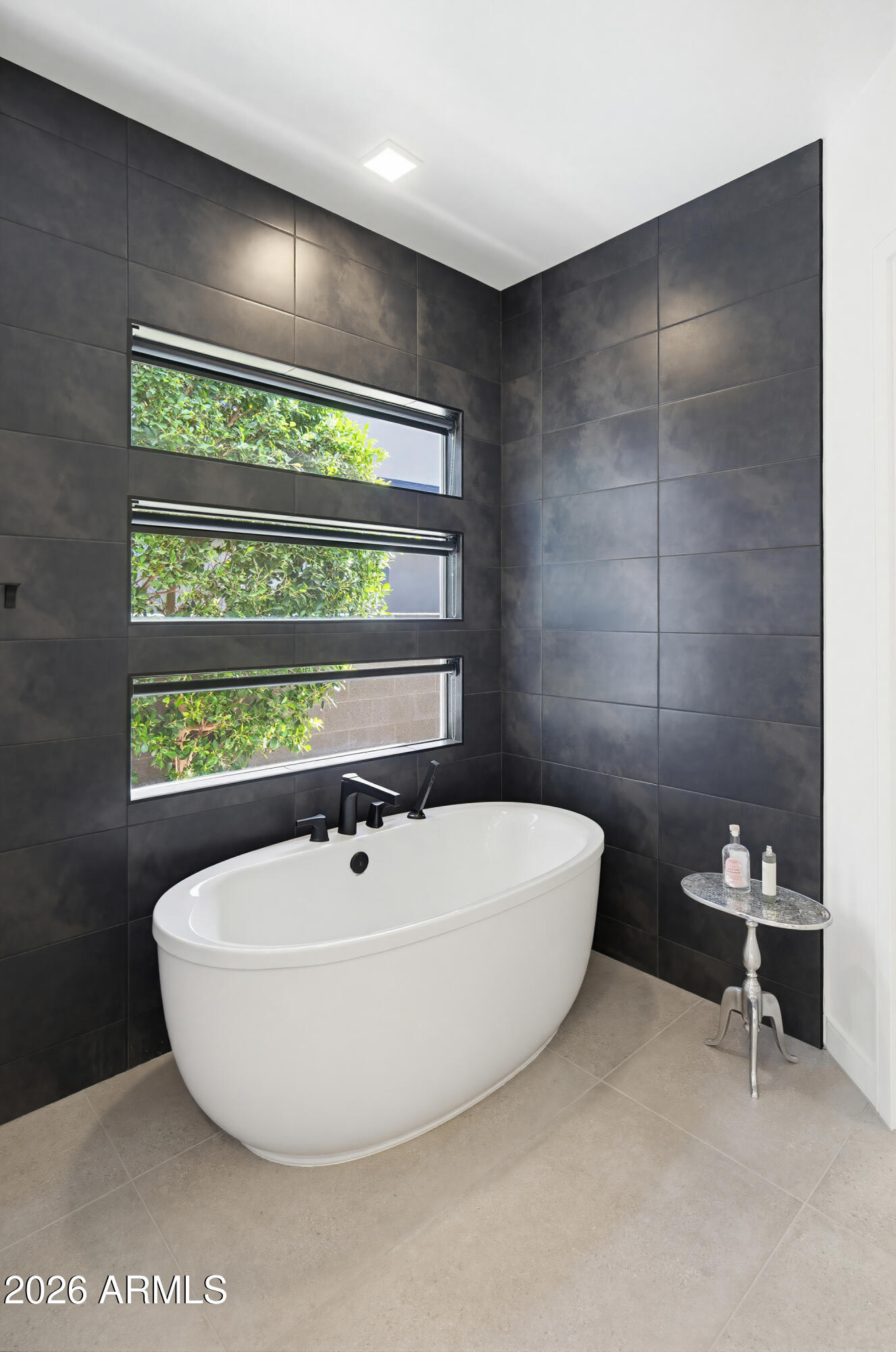 3350 East Highline Canal Road Phoenix, AZ 85042 - Photo 32 of 105 a bathroom with a bathtub and a window