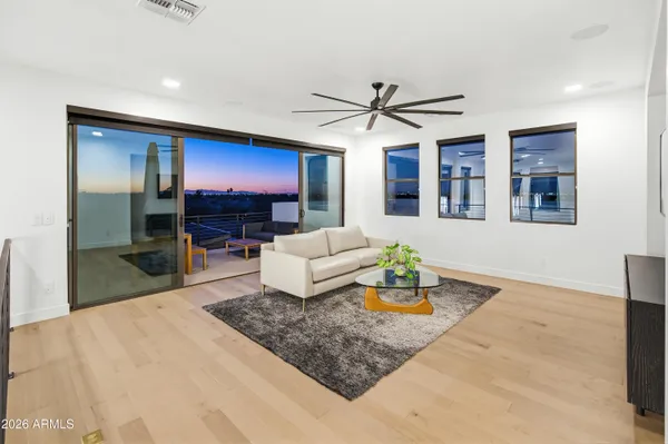 a living room with patio furniture and garden