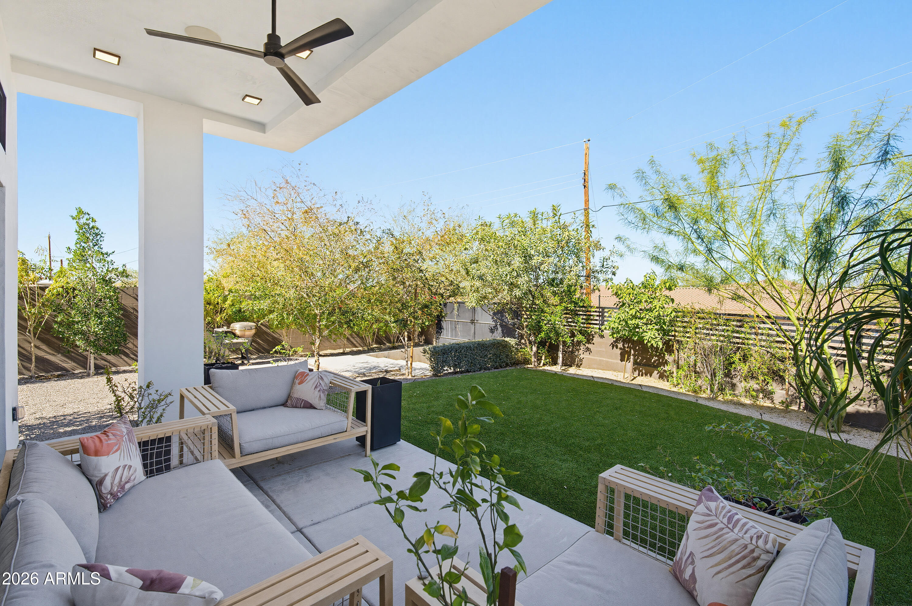 3350 East Highline Canal Road Phoenix, AZ 85042 - Photo 76 of 105 a view of a patio with couches potted plants and a big yard