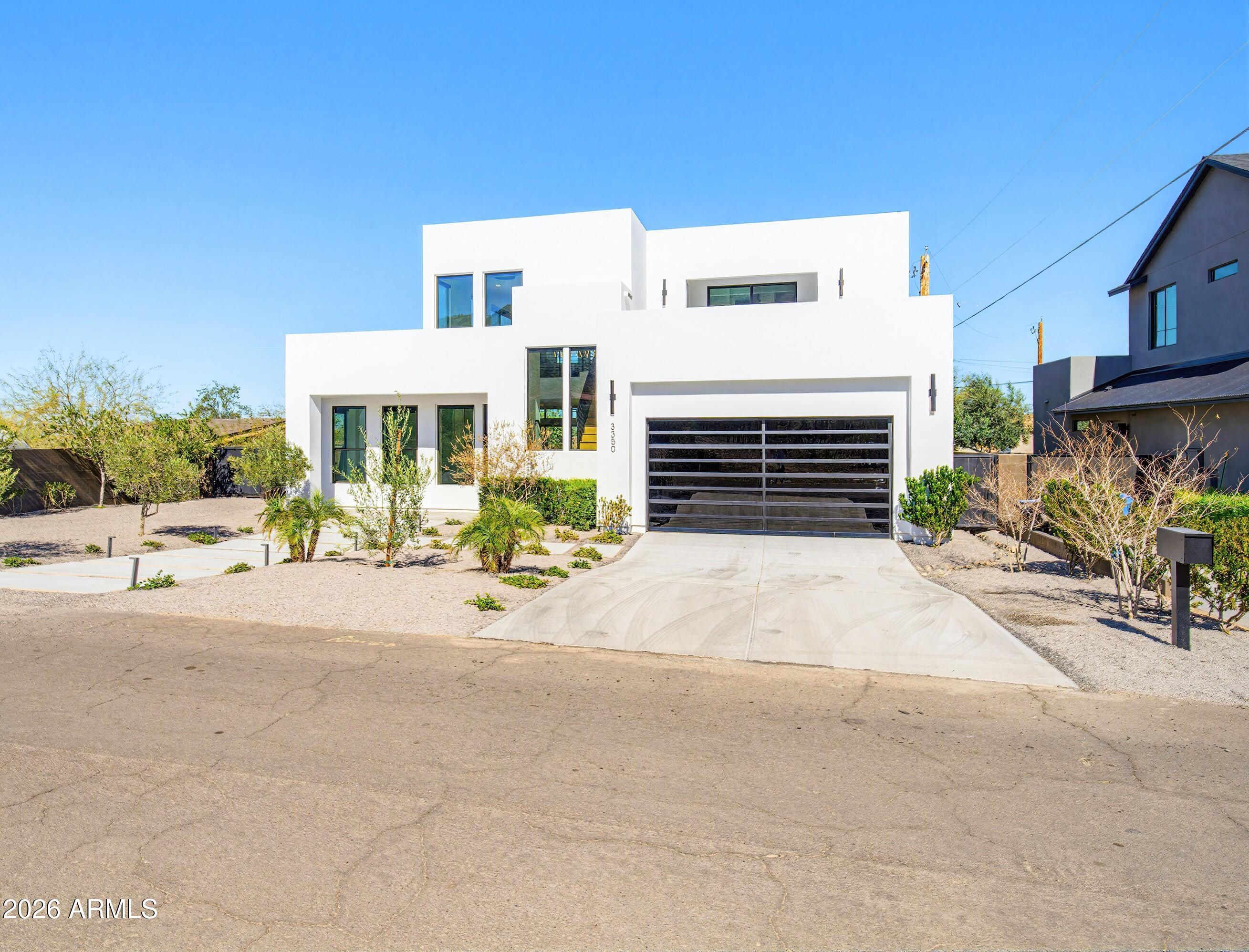 3350 East Highline Canal Road Phoenix, AZ 85042 - Photo 83 of 105 a front view of a house with a yard and a garage