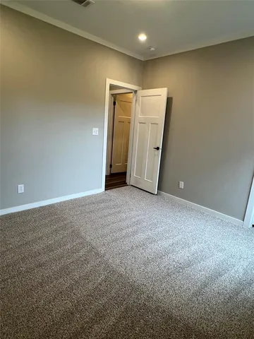 a bathroom with a granite countertop toilet sink and mirror