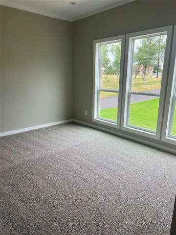 an empty room with large windows