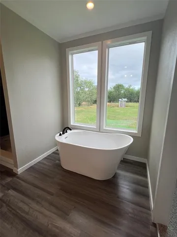 a bathroom with a bathtub and window