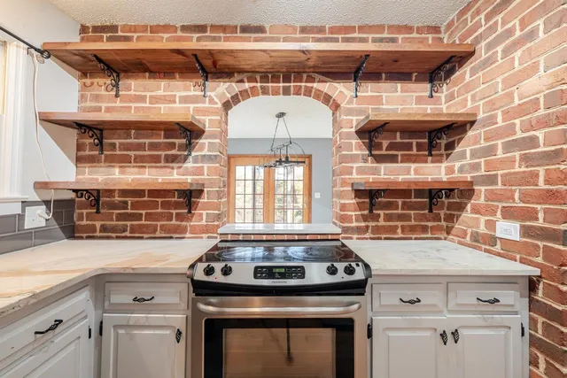 a stove top oven sitting inside of a kitchen