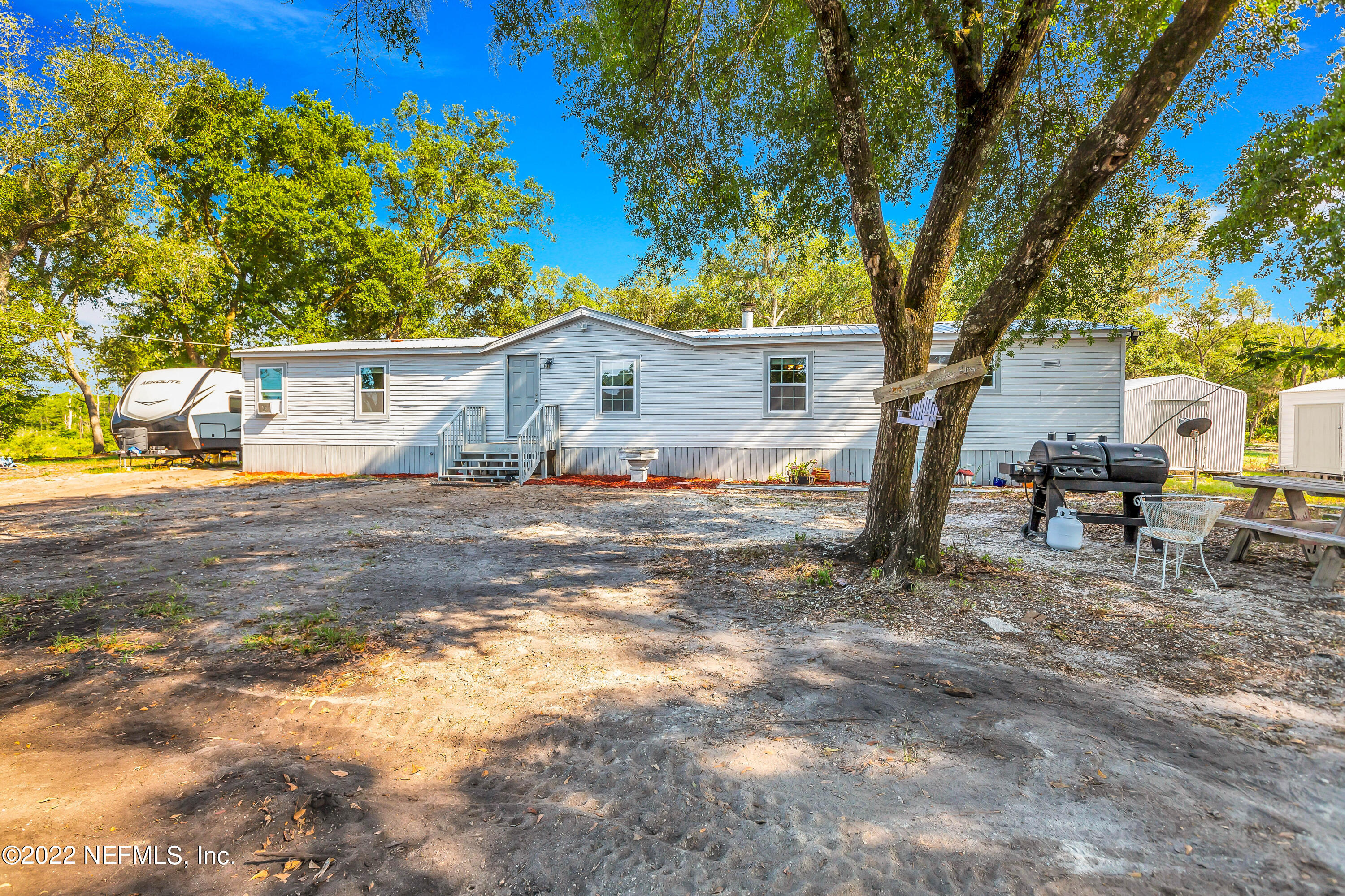 8049 Blazing Star Road Melrose, FL 32666 - Photo 4 of 39 a view of a house with a tree in the background