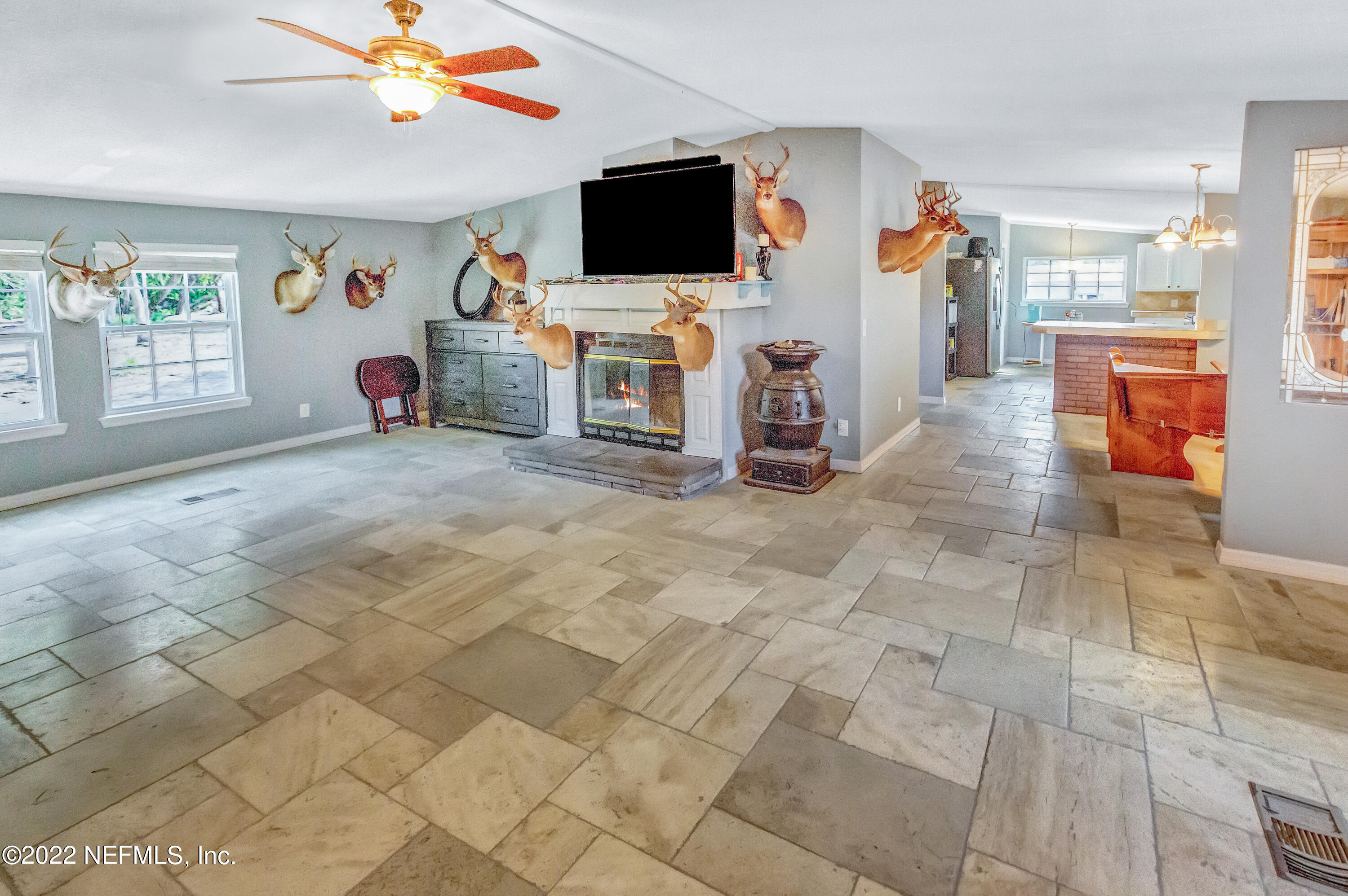 8049 Blazing Star Road Melrose, FL 32666 - Photo 8 of 39 a view of a livingroom with furniture and a flat screen tv