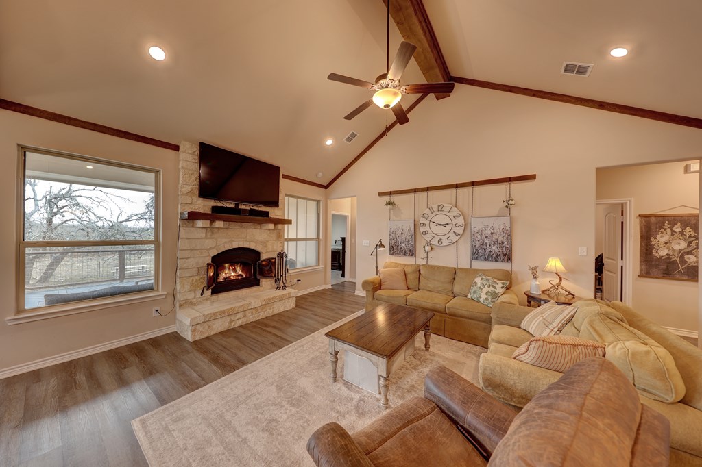 450 Jung Road Harper, TX 78631 - Photo 3 of 50 a living room with furniture a fireplace and a flat screen tv