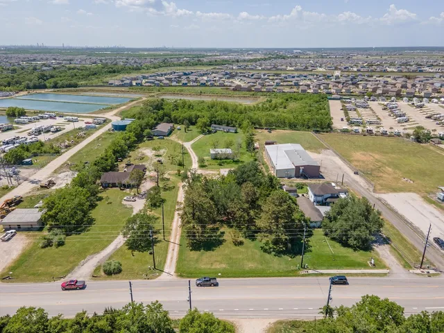 an aerial view of residential houses with outdoor space