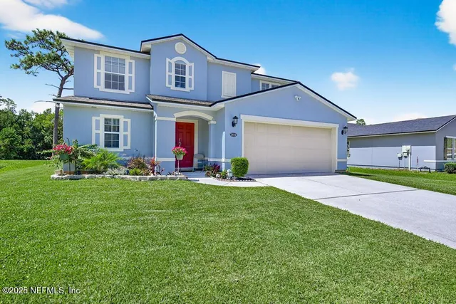 a front view of a house with a yard and garage