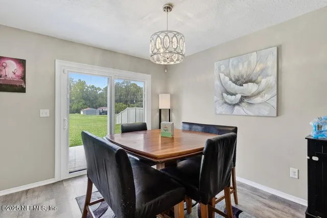 a view of a dining room with furniture wooden floor and a chandelier