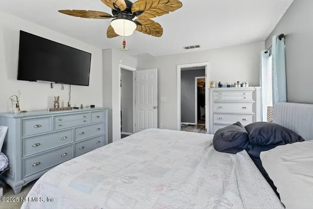 a bedroom with a bed and a flat screen tv