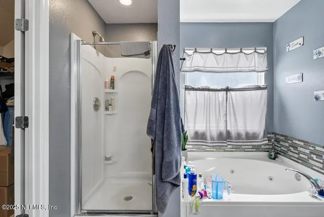 a bathroom with a bathtub and a shower