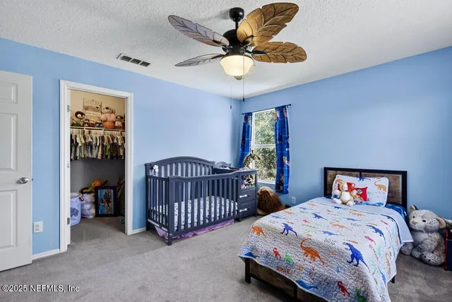 a bedroom with a bed and a chandelier in it