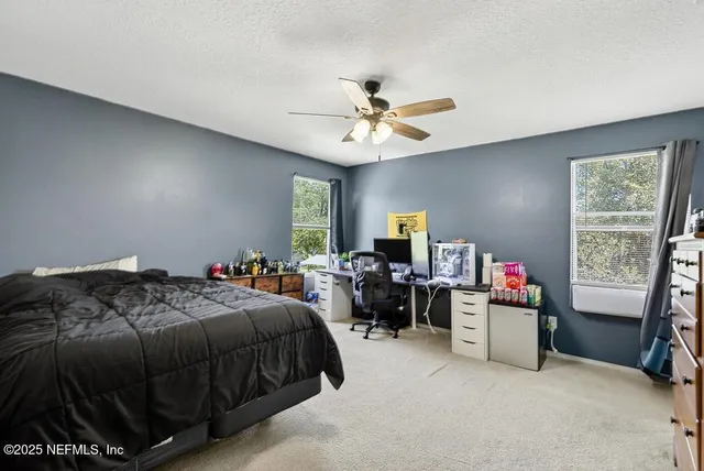 a bedroom with a bed gym equipment and a window