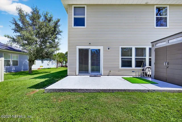 a view of a house with backyard porch and garden